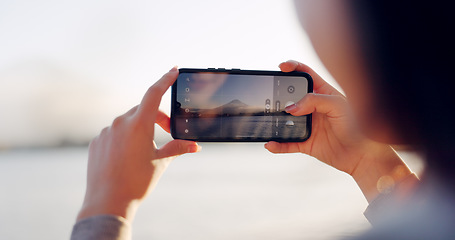 Image showing Hands, phone and photography by lake, mountain and nature with landscape, horizon and outdoor adventure. Person, smartphone screen and camera for Mt Fuji, memory and post on social media in Japan