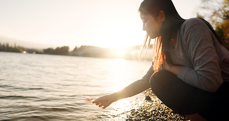 Image showing Japanese woman, red maple leaf and Lake Kawaguchi with game, thinking or memory in nature, adventure or holiday. Girl, plant and sunrise for vacation by forest, environment or waves by water in Tokyo