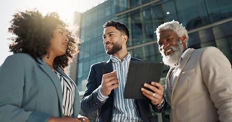 Image showing Business people, outdoor and walking with conversation, tablet and New York city with professionals. Corporate, urban town and group with ideas, technology and summer with social media and connection