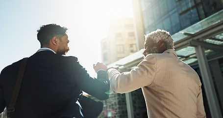 Image showing Business men, fist bump and team in street with smile, support and respect on walk to investment company. Partnership, friends and staff with hello, happy and commute on city sidewalk in Cape Town