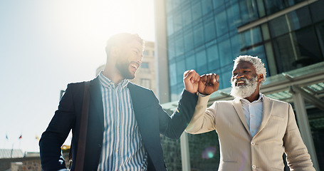 Image showing Business men, fist bump and team in street with smile, support and respect on walk to investment company. Partnership, friends and staff with hello, happy and commute on city sidewalk in Cape Town