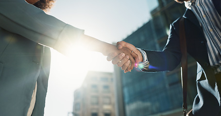 Image showing Outdoor, business people and professional with handshake, conversation and contract with lens flare, corporate and talk. Staff, employees in a city and coworkers with hello, partnership or urban town