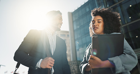 Image showing Outdoor, business people and conversation with handshake, greeting and contract with lens flare, corporate and smile. Travel, employees in a city and coworkers with hello, partnership and friends