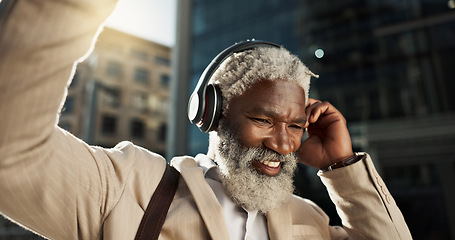 Image showing Happy, dancing and senior businessman with headphones in the city walking and listening to music. Smile, happy and elderly African male person streaming playlist, song or radio commuting in town.