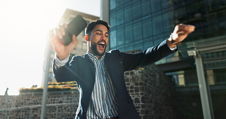Image showing Phone, dance and success with a businessman in the city for increase, bonus or promotion celebration. Wow, mobile and a winner young employee cheering for goals, target or corporate achievement