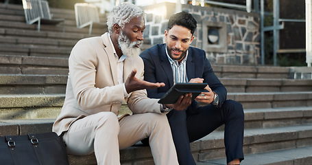 Image showing Tablet, conversation and business men in the city in discussion for corporate legal case. Teamwork, collaboration and male attorneys with digital technology sitting and talking on stairs in town.