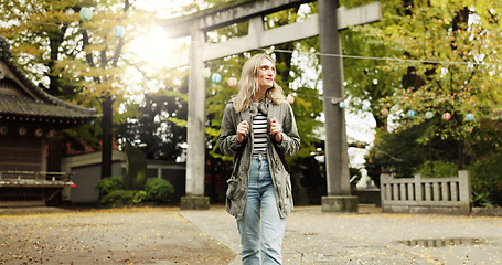 Image showing Woman, nature and torii gate in Kyoto with wow, surprised and travel with spiritual history. Architecture, japanese culture and shinto shrine in woods with sculpture, memorial and monument landscape