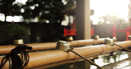 Image showing Shinto temple, closeup and fountain with water in container for faith, clean or washing hands for wellness. Religion, mindfulness or praise with purification ritual in woods, peace or shrine in Kyoto