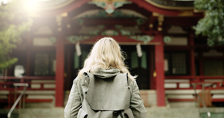 Image showing Torii gate, woman or back in japan for worship, holy or prayer location for peace in culture. Kyoto architecture, person and Fushimi Inari Taisha with religion and gateway of sacred to shinto shrine