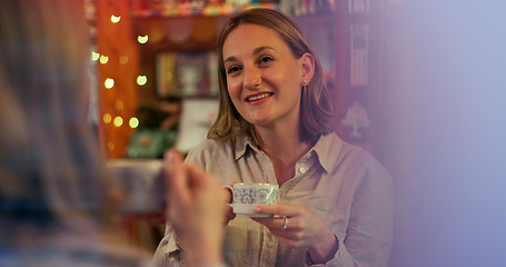 Image showing Women, friends and talk in coffee shop, drink and happy for reunion, date and conversation on break. Girl, people and smile for chat, memory and relax with tea cup, latte or espresso in cafe together