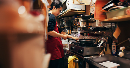 Image showing Japanese chef man, stove and pan for cooking, service or catering job with heat, flame and ready. Person, restaurant or cafeteria in kitchen for meal prep, working or thinking with recipe in Tokyo