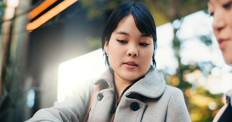 Image showing Businesswomen, japan and talking by office buildings in city, collaboration and discussion in corporate career. Manager, employee and communication in professional job in tokyo and project feedback