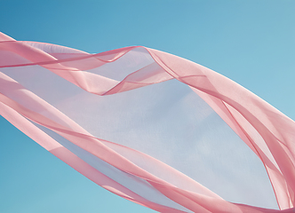 Image showing Flying pink transparent fabric wave on blue background and illum