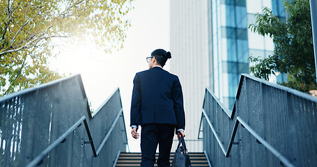 Image showing Stairs, walking and back of businessman in the city by office building for travel with career. Outdoor, energy and professional male person commuting on steps to modern workplace in urban town.