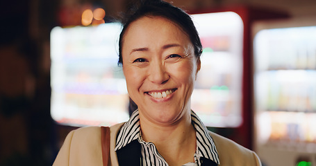 Image showing Japanese business woman, night and face with funny smile, laughing and excited by vending machine. Person, corporate employee and happy mature worker in dark lobby, workplace and portrait in Osaka