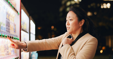 Image showing Woman, thinking and choice at vending machine for food or hot drink with in city at night. Shopping, automatic service and customer with click button and press on decision downtown in Tokyo Japan