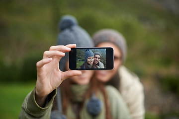Image showing Couple, selfie and photo while hiking in nature, smartphone and capture moment in outdoors. People, happy and picture for memory and exploring wilderness, trekking and photograph for social media