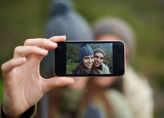 Image showing Couple, hiking and smartphone for selfie in nature, camera and capture moment in outdoors. People, happy and picture for memory and exploring wilderness, trekking and photograph for social media