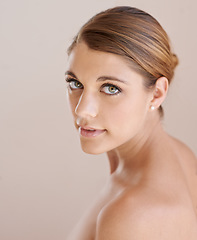 Image showing Portrait, natural beauty and skincare of woman in studio isolated on a brown background. Serious face, shoulder and young model in cosmetics, healthy skin glow or spa facial treatment for dermatology