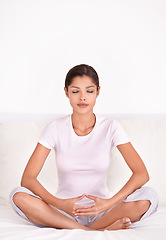 Image showing Relax, calm and young woman with meditation for peace, zen and mindful wellness on bed. Serenity, health and female person in position for spiritual chakra balance in bedroom at apartment.