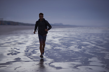 Image showing Running, beach and man with fitness travel and exercise with wellness, explore and ocean. Person, runner and guy with fun, water and sunset with break and breathing with workout, energy and Miami