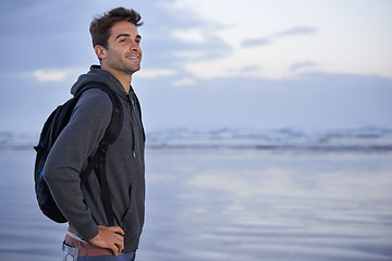 Image showing Thinking, beach and man with vacation, travel and backpack with happiness, smile or getaway trip. Person, seaside or traveller with nature or wellness with water, explore or holiday with summer break