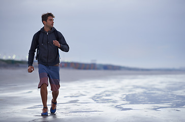 Image showing Running, beach and man with vacation, health and exercise with nature, energy and ocean. Person, runner and guy with fun, water and sunset with wellness and explore with workout, cardio and Miami.