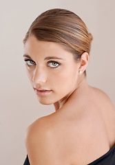 Image showing Portrait, beauty and serious woman in studio isolated on a brown background. Face, shoulder and young model shine in cosmetics, healthy skin glow and spa facial treatment for skincare dermatology