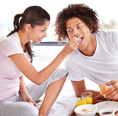 Image showing Couple, feeding and breakfast in bed on vacation, healthy meal and celebrating anniversary at home. People, marriage milestone and love or loyalty in relationship, romance and food for nutrition