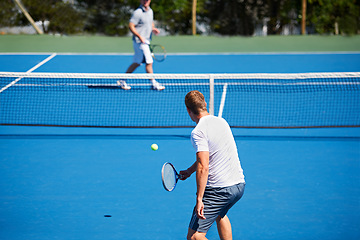 Image showing Tennis, game and men with fitness, sports and competition with training and exercise. Players, friends and guys with rackets and court with workout and sunshine with challenge and cardio with a ball
