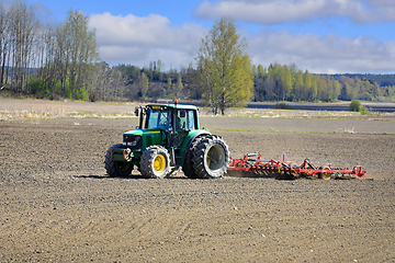 Image showing John Deere Tractor and Tine Harrow in Field