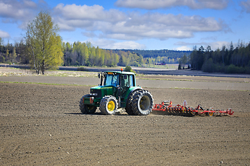 Image showing John Deere Tractor and Vaderstad Tine Harrow in Field