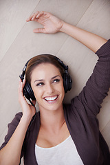 Image showing Top view, headphones or happy woman on floor for music streaming, mental health or wellness. Smile, thinking or fun female person on break listening to audio, radio song or track to relax in home