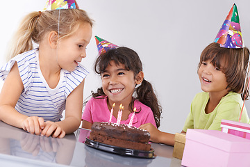 Image showing Friends, children and birthday cake, party and candles with happy people for celebration, youth and dessert. Special day, together in festive mood and kids smile for social event with chocolate