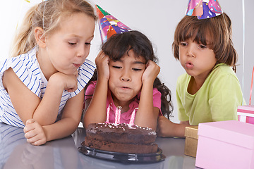 Image showing Friends, kids and birthday cake, blow candles at party with people for celebration, youth and dessert. Special day, together in festive mood and children smile for social event with chocolate