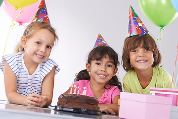 Image showing Friends, children in portrait and birthday cake, party and candles with happy people celebrate, youth and dessert. Special day, together in festive mood and kids smile for social event with chocolate