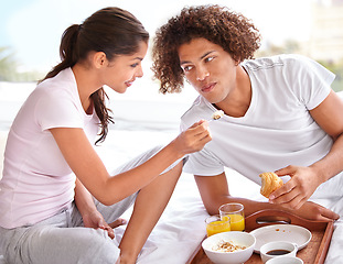 Image showing Couple, feeding and breakfast in bed for bonding, healthy meal and celebrating anniversary at home. People, marriage milestone and love or loyalty in relationship, romance and food for nutrition