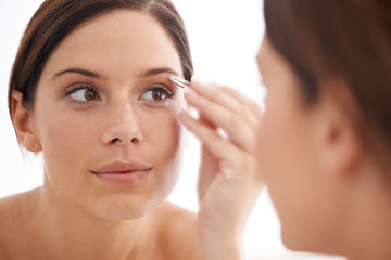 Image showing Plucking, eyebrow and woman in mirror with beauty, tweezers and self care in bathroom. Makeup, routine and girl with hair removal, tools and facial grooming for skincare and cosmetics results