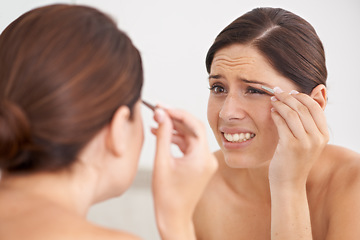 Image showing Eyebrow, plucking and woman with pain for beauty, self care and mirror in bathroom. Makeup, routine and girl with hair removal, tools and facial grooming or treatment for skincare and cosmetics