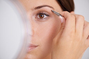 Image showing Eyebrow, hair removal and woman closeup with beauty, self care and mirror in bathroom. Makeup, routine and girl with tweezers, tools and plucking face for grooming results in skincare and cosmetics