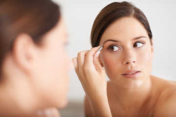 Image showing Beauty, mirror and woman with tweezers for eyebrow maintenance, hair removal or cosmetic treatment. Home bathroom, morning self care or person with mirror, microblading and plucking for face grooming