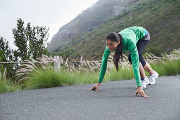 Image showing Woman, on her mark and start running for fitness, race or marathon with athlete training outdoor. Runner is ready for exercise, cardio and speed with challenge, sports for health and wellness