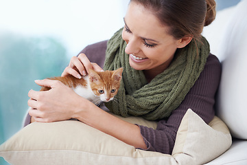 Image showing Happy, sofa and woman with kitten in home for bonding, friendship and relax together in house. Animal care, pets and person with adorable, cute and young cat on couch for playing, affection and love