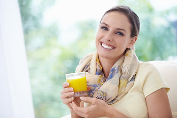 Image showing Portrait, smile or happy woman in home with orange juice for vitamin c in lounge to relax on a break. Apartment, wellness or female person drinking a fresh beverage for healthy nutrition or hydration