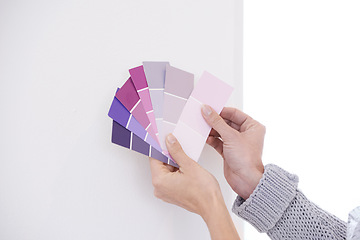 Image showing Hands, color swatches for interior design and paint choice, home renovation and person for development and plan. DIY project, painter decision and palette for creativity and decor on wall background