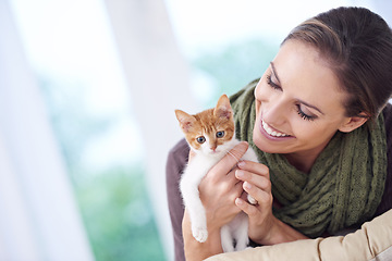 Image showing Happy, love and woman with kitten in home for bonding, friendship and relax together on sofa. Animal care, house and person with adorable, cute and young cat on couch for playing, embrace and hug