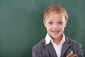 Image showing Child, portrait and chalkboard for school education in classroom for learning, writing or homework. Female person, uniform and kindergarten development or brainstorming or knowledge, study or mockup