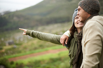 Image showing Travel, hiking and pointing with couple in mountains together for love, dating or sightseeing. Smile, environment or view with happy young man and woman in nature for adventure, holiday or vacation