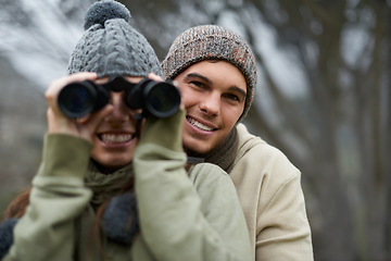 Image showing Binoculars, nature and happy couple in forest, journey and adventure in hiking portrait for carbon footprint travel. Face of young man and woman with outdoor gear for birdwatching in winter and woods