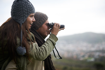 Image showing Couple, travel and binoculars on mountains for journey, adventure and hiking or explore together with cityscape. Man and woman trekking with outdoor search, vision or birdwatching lens in tourism